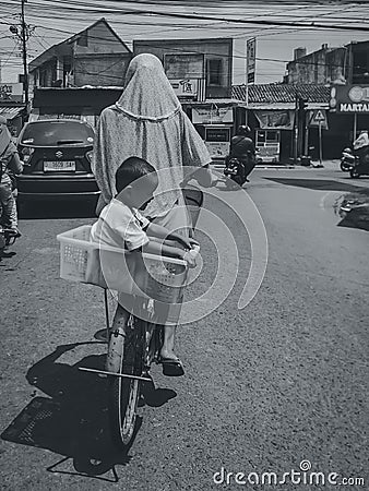 A woman rides a bicycle on the road, Tasikmalaya 30 September 2023 Editorial Stock Photo