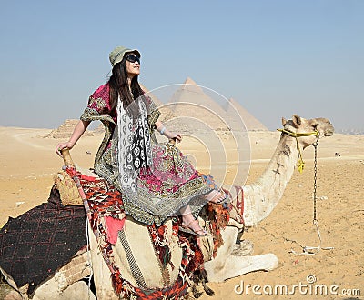 Woman riding camel Stock Photo