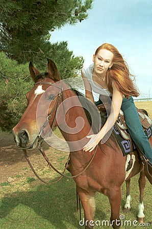 Woman riding horse Stock Photo