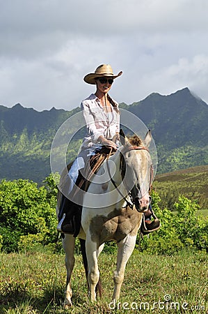 Woman riding a horse Stock Photo