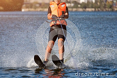 Woman riding water skis closeup. Body parts without a face. Athlete water skiing and having fun. Living a healthy Editorial Stock Photo