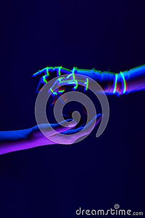 Woman and robot`s hands as a symbol of connections between people and technology. Neon colors. Stock Photo