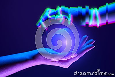 Woman and robot`s hands as symbol of partnership between people and technology. Stock Photo