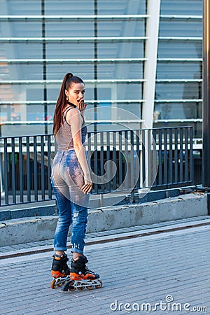 Woman on rollerblades looking back. Stock Photo