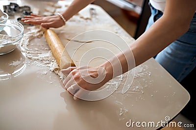 Woman rolling out pastry in the kitchen Stock Photo