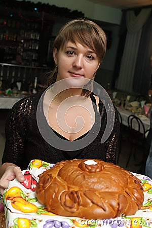 Woman with round loaf Stock Photo