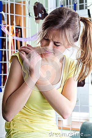 Woman rubbing aching shoulder Stock Photo