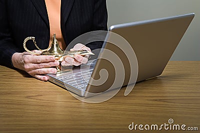 Woman rubbing genie lamp Stock Photo