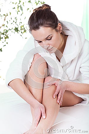 Woman rubbing her leg Stock Photo