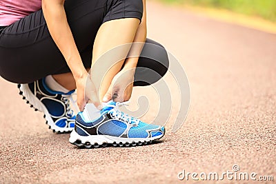 Woman runner holder her twisted ankle Stock Photo