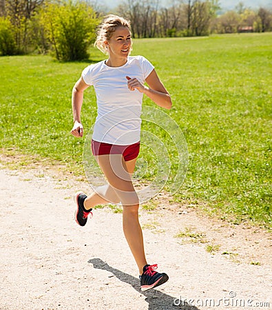 Woman runner runs - workout in spring Stock Photo