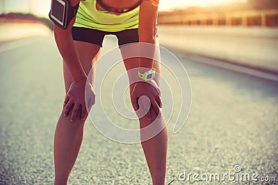 Woman runner taking a rest after running city road Stock Photo