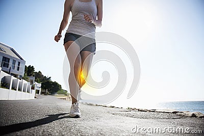 Woman, running and knee x ray for injury, workout or sport accident during exercise or run in the city. Female runner in Stock Photo