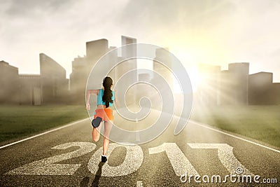 Woman running at street with 2017 Stock Photo