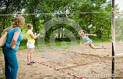 Woman runs trying to repel flying shuttlecock during amateur competitions of beach tennis Editorial Stock Photo