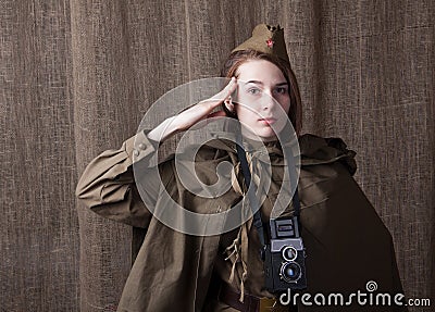 Woman in Russian military uniform with camera. Female war correspondent during the second world war. Stock Photo