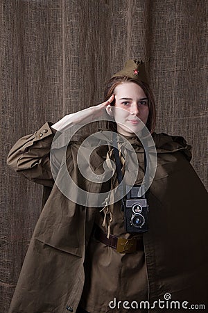 Woman in Russian military uniform with camera. Female war correspondent during the second world war. Stock Photo