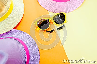 Woman`s accessories lying flat on textured fabric background. Blue and yellow pastel colors with copy space around products. Stock Photo