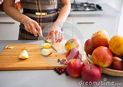 Woman's elegant hands cutting apples on board Stock Photo