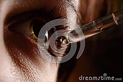 Woman`s eye and eyedropper Stock Photo