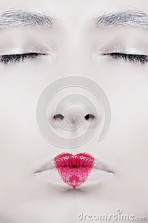 The woman`s face close-up with lips painted in the shape of hear Stock Photo