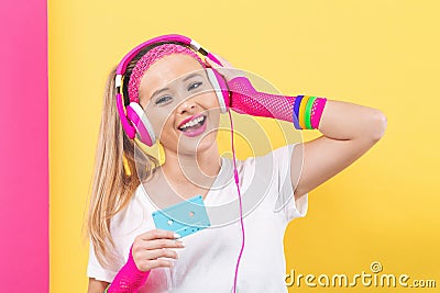 Woman in 1980`s fashion holding a cassette tape Stock Photo