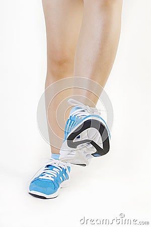 Woman's feet wearing sports trainers Stock Photo