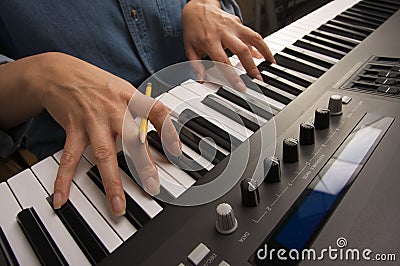 Woman's Fingers on Digital Piano Keys Stock Photo