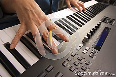 Woman's Fingers on Digital Piano Keys Stock Photo