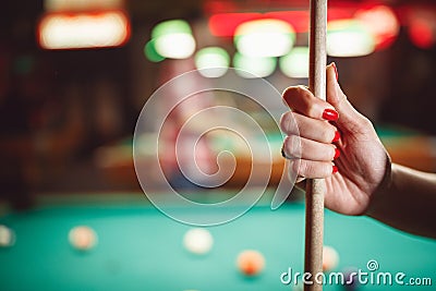 Woman`s hand with cue for playing billiard Stock Photo
