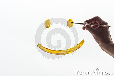 Woman& x27;s hand draws a smiling face on a white background, close-up. A symbol of hope, happiness, joy Stock Photo