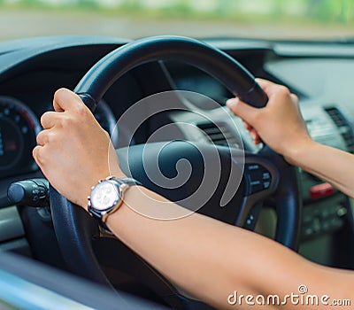 Woman's hand driving a car. Stock Photo