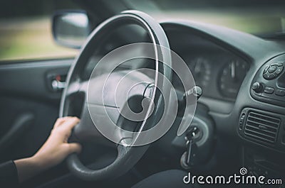 Woman's hand driving a car. Stock Photo