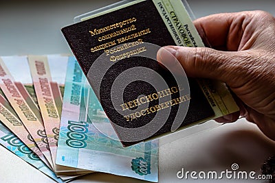 Woman`s hand holding russian pension certificate. Stock Photo
