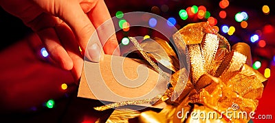 A woman's hand holds a label on a gift box. Stock Photo