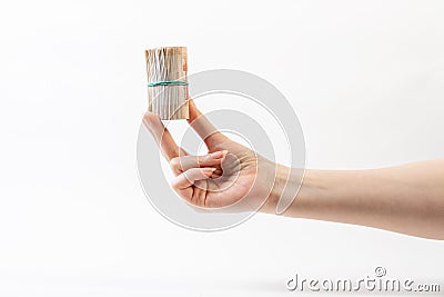 A woman`s hand holds a roll of money. Side view, close-up. White background. The concept of the world anti-corruption day Stock Photo