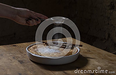 Woman`s hand icing apple pie Stock Photo