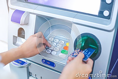 Woman`s hand pressing PIN/pass code on ATM/bank machine keypad Stock Photo