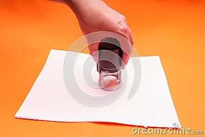 Woman`s hand with the seal, stamp. Process stamping the contract, documents, close up. Stock Photo