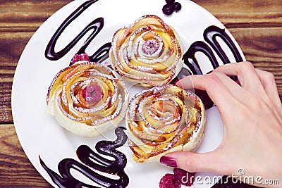 Woman`s hand take one of three apple muffins Stock Photo