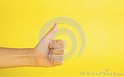 A woman's hand with thumb up finger like gesture Stock Photo