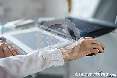 Woman's hand using cordless mouse Stock Photo