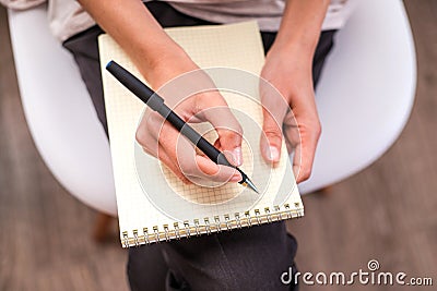 Woman`s hand writing on an blank notebook. Stock Photo