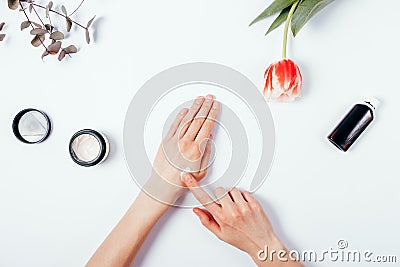 Woman's hands apply cream on skin to test it. Top view. Stock Photo