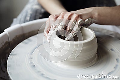 The woman`s hands close up, the masterful studio of ceramics works with clay on a potter`s wheel. Stock Photo