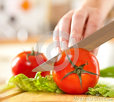 Woman's hands cutting vegetables Stock Photo