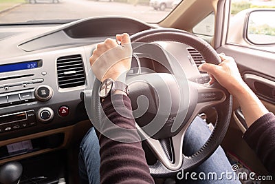 Woman`s hands of a driver on steering wheel of a car Stock Photo