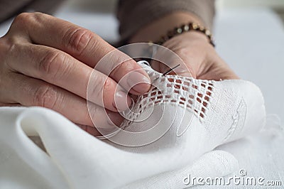 Woman`s hands embroider ornaments Stock Photo