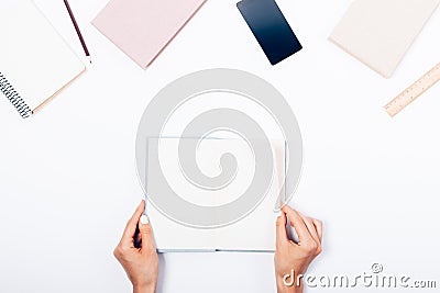 Woman's hands flipping through the book, top view Stock Photo