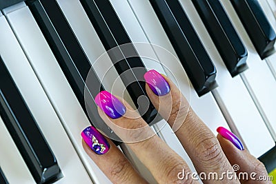 Woman`s hands on the keyboard of the piano closeup. Hands musician playing the piano. Top view. Hands pianist playing music on th Stock Photo